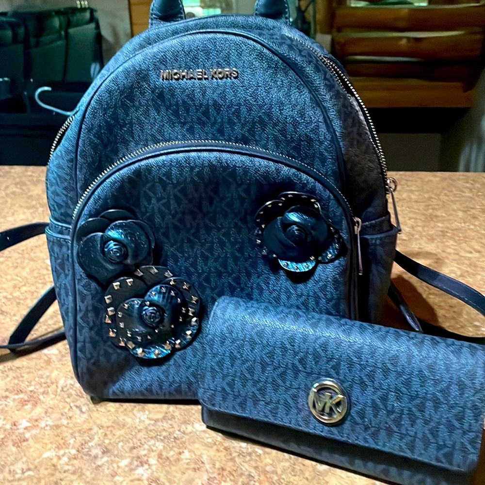 Michael Kors backpack.  Navy Blue with silver hardware has matching wallet.
